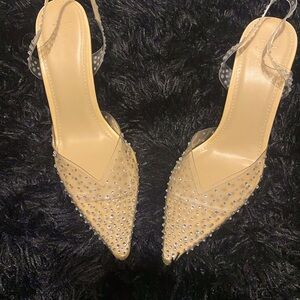 3.5 inch heel.  Closed toe vinyl shoe covered in rhinestones.